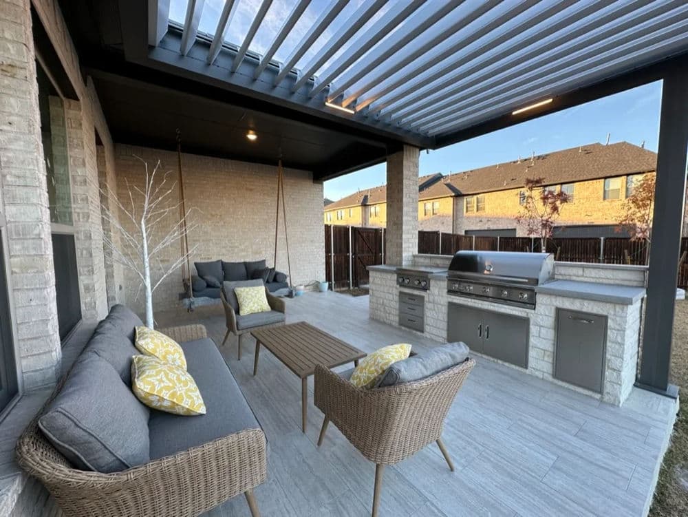 Modern outdoor patio with grill, seating area, and pergola, perfect for entertaining.